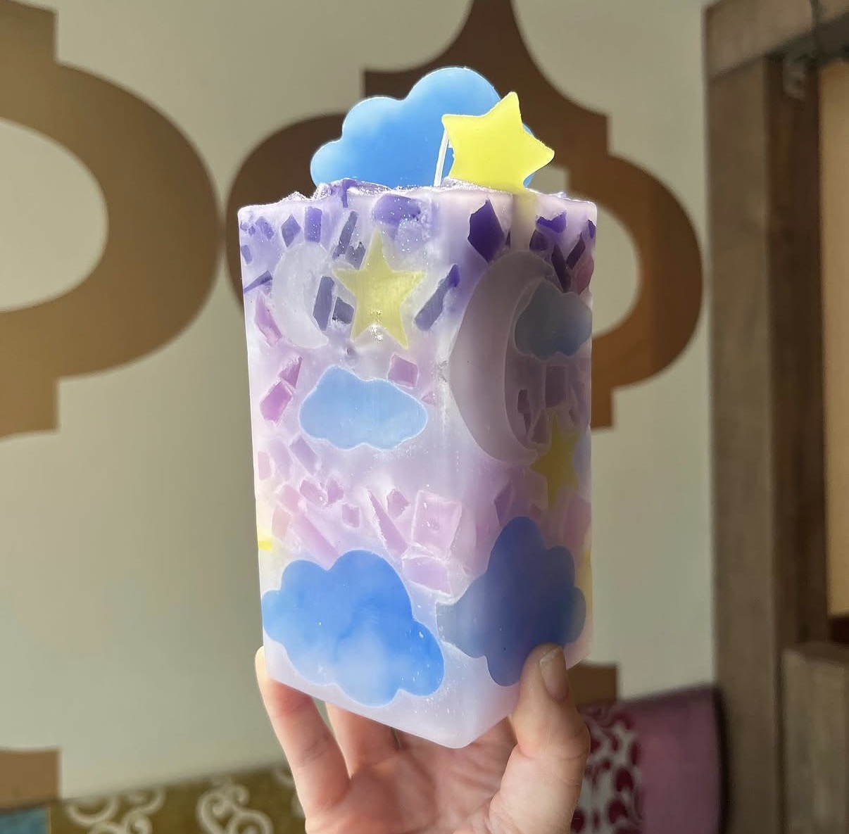 Purple cloud and star themed candle made at Glow Candle Lounge