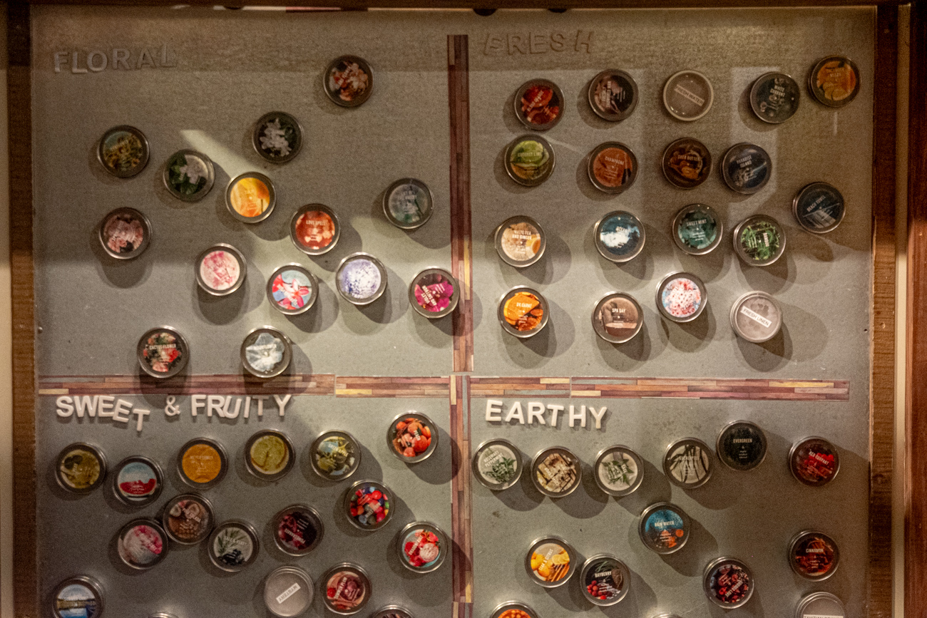 Fragrance wall organized by floral, fresh, sweet & fruity, and earthy scents at Glow Candle Lounge