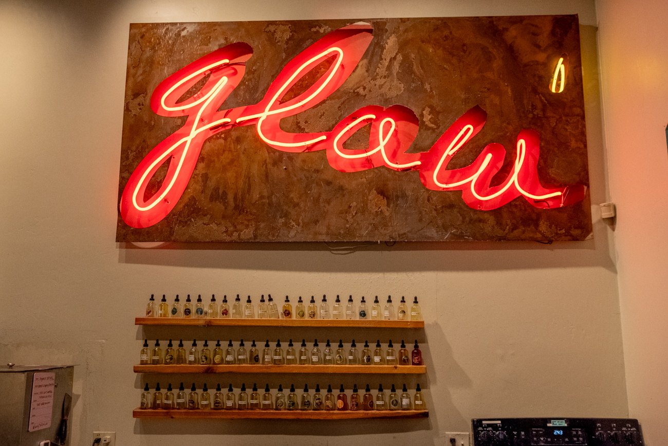 Glow neon sign and fragrance wall at Glow Candle Lounge